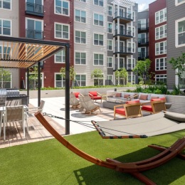 a hammock and seating area in a courtyard