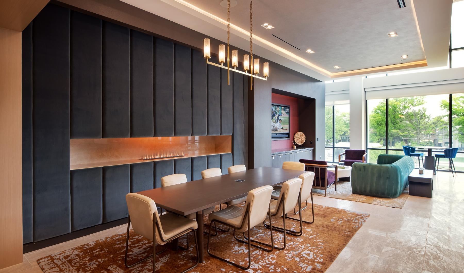 a clubroom with a table, chairs and a couch