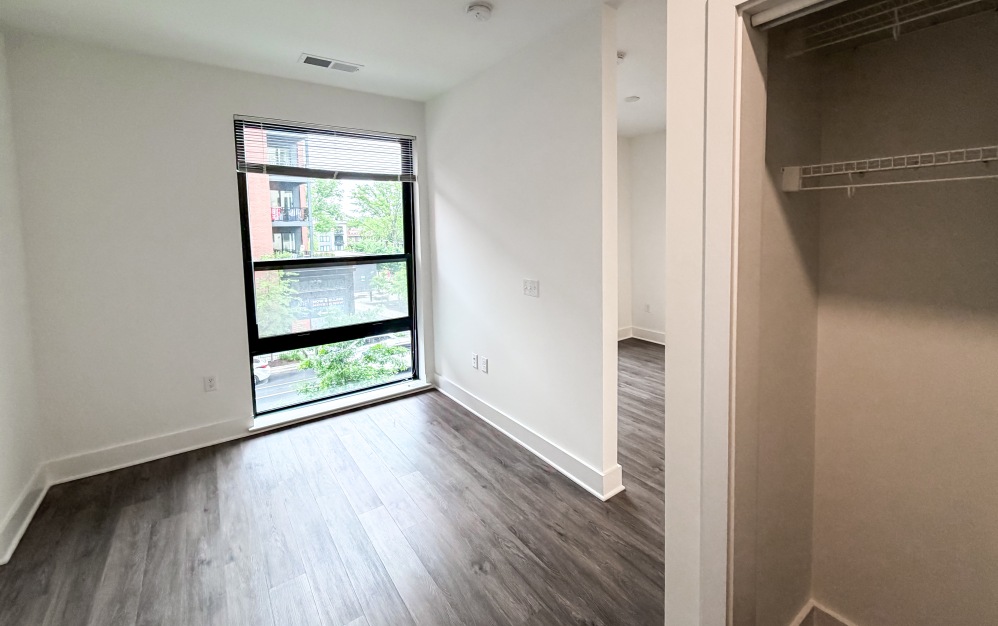 Modern apartment bedroom with large windows in The Hartley DC