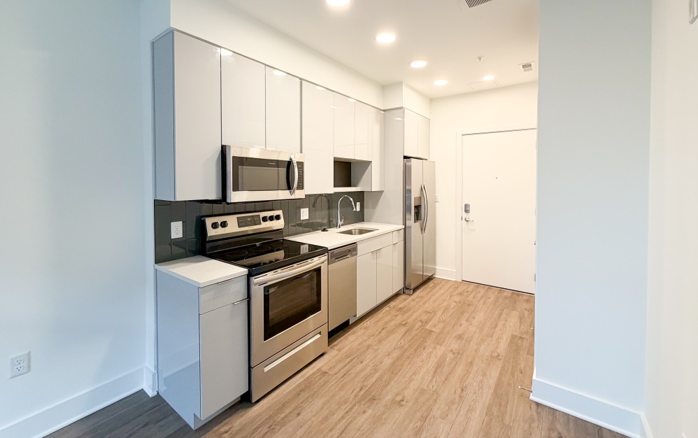 Modern kitchen with stainless steel appliances at The Hartley apartments Washington DC