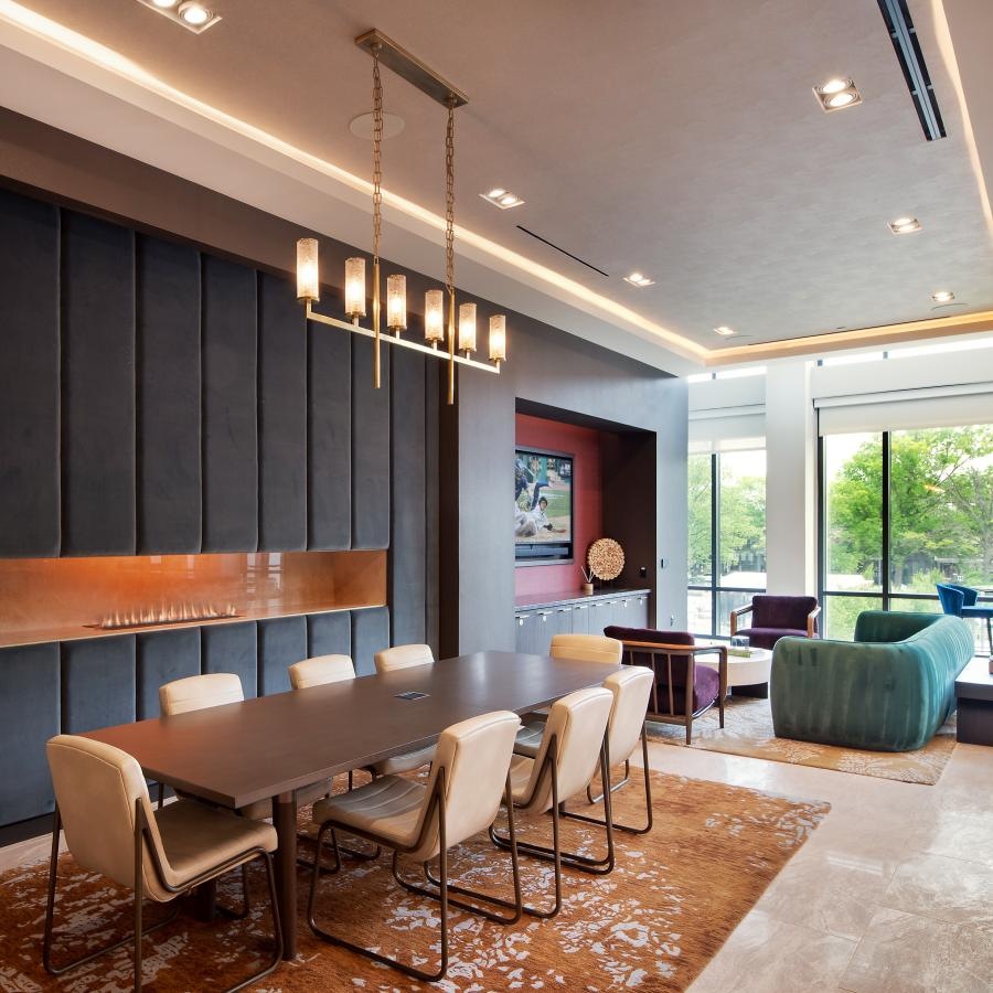 a clubroom with a table, chairs and a couch